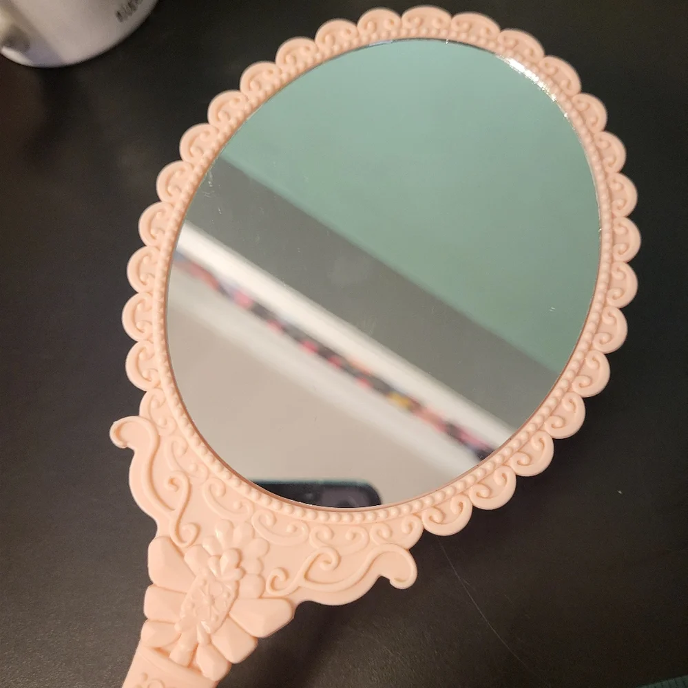 Pink plastic fantasy hand mirror